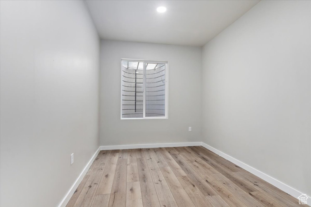 Spare room featuring light wood finished floors and baseboards