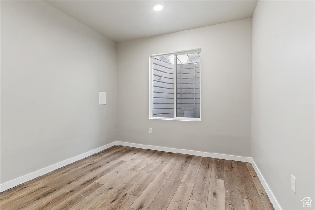 Spare room with hardwood / wood-style floors and recessed lighting