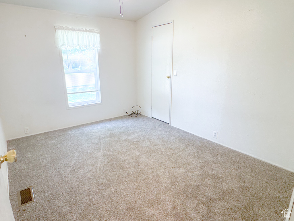 Unfurnished room featuring carpet flooring