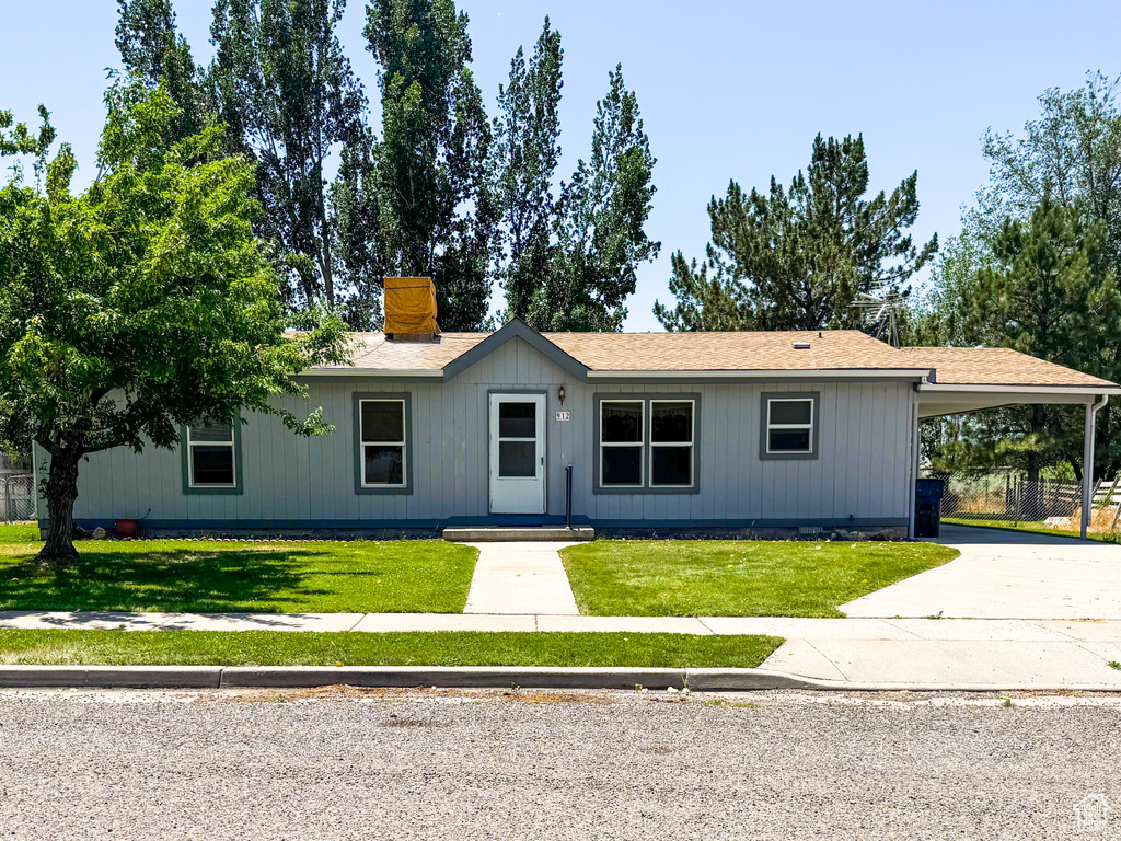Ranch-style home with an attached carport and driveway