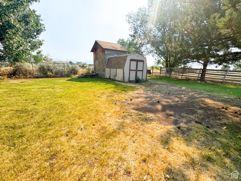 Fenced backyard with a storage shed
