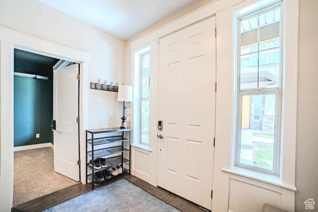 Foyer entrance with wood finished floors and baseboards