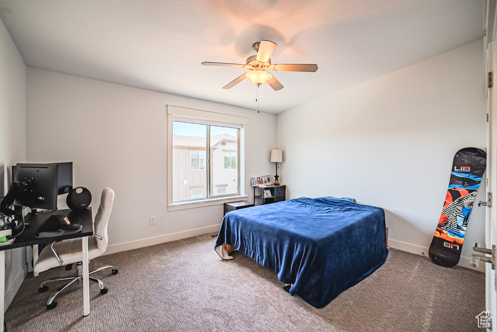Bedroom featuring carpet floors, a desk, and a ceiling fan