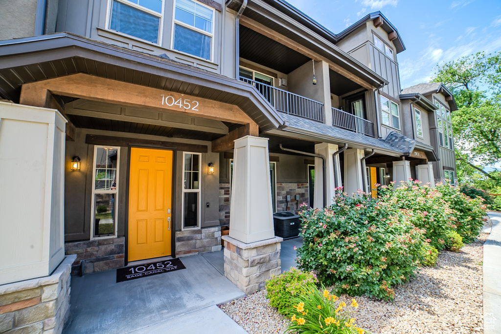 Doorway to property featuring stone siding and stucco siding