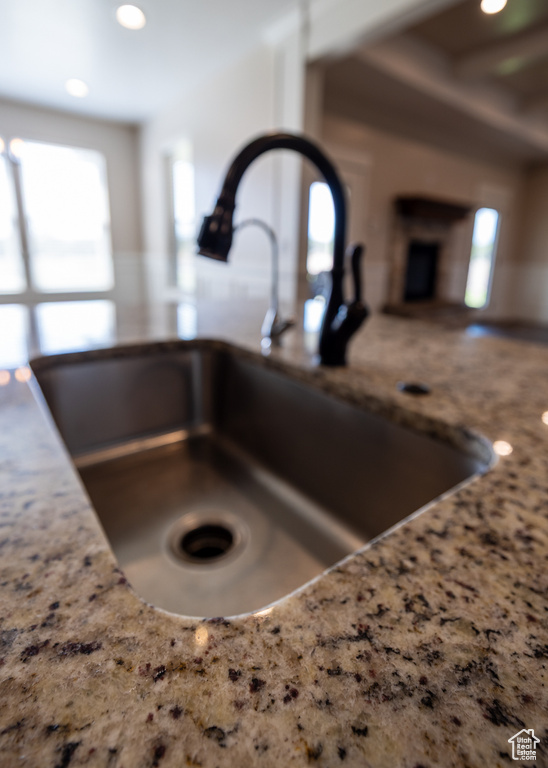 Kitchen view of light stone countertops and recessed lighting