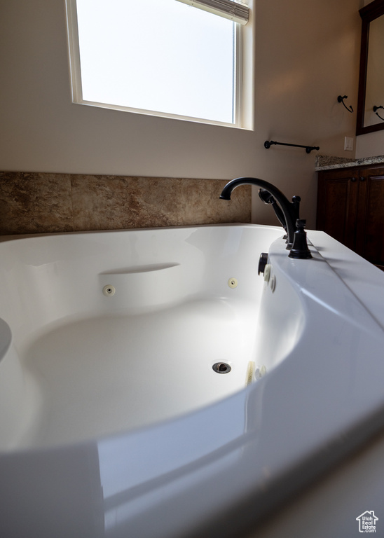 Full bath featuring a jetted tub