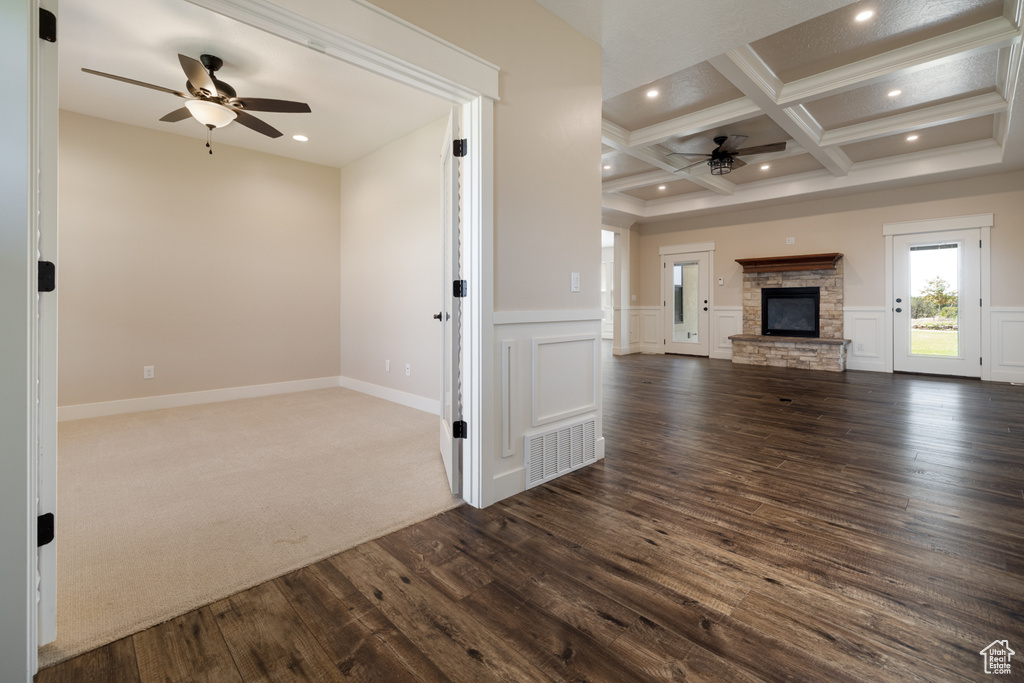 Unfurnished living room with a ceiling fan, coffered ceiling, dark wood-style flooring, beam ceiling, and recessed lighting