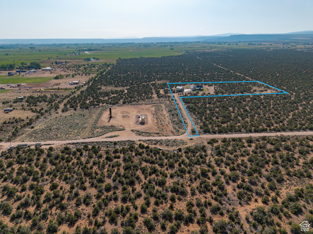 Aerial view of sparsely populated area with property parcel outlined