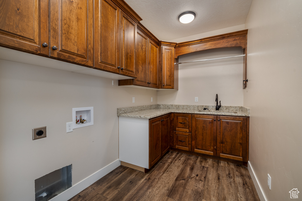 Laundry area featuring electric dryer hookup, cabinet space, hookup for a washing machine, and dark wood finished floors