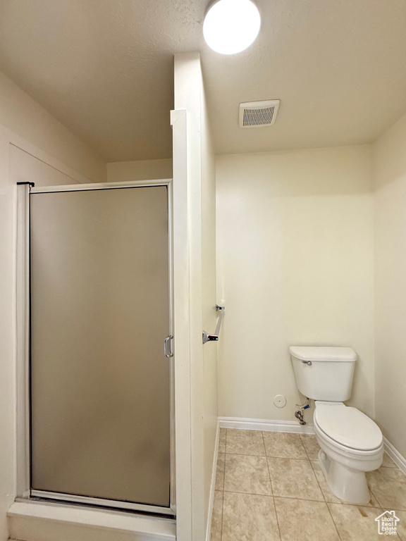 Bathroom featuring a stall shower and tile patterned floors