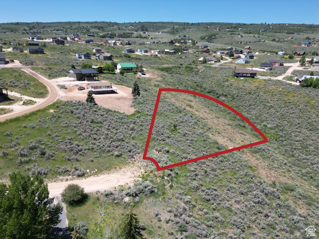 Aerial overview of property's location with property boundaries highlighted and rural landscape