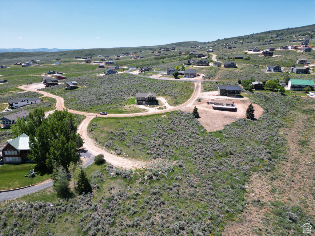 Aerial view of property's location with rural landscape and a mountainous background
