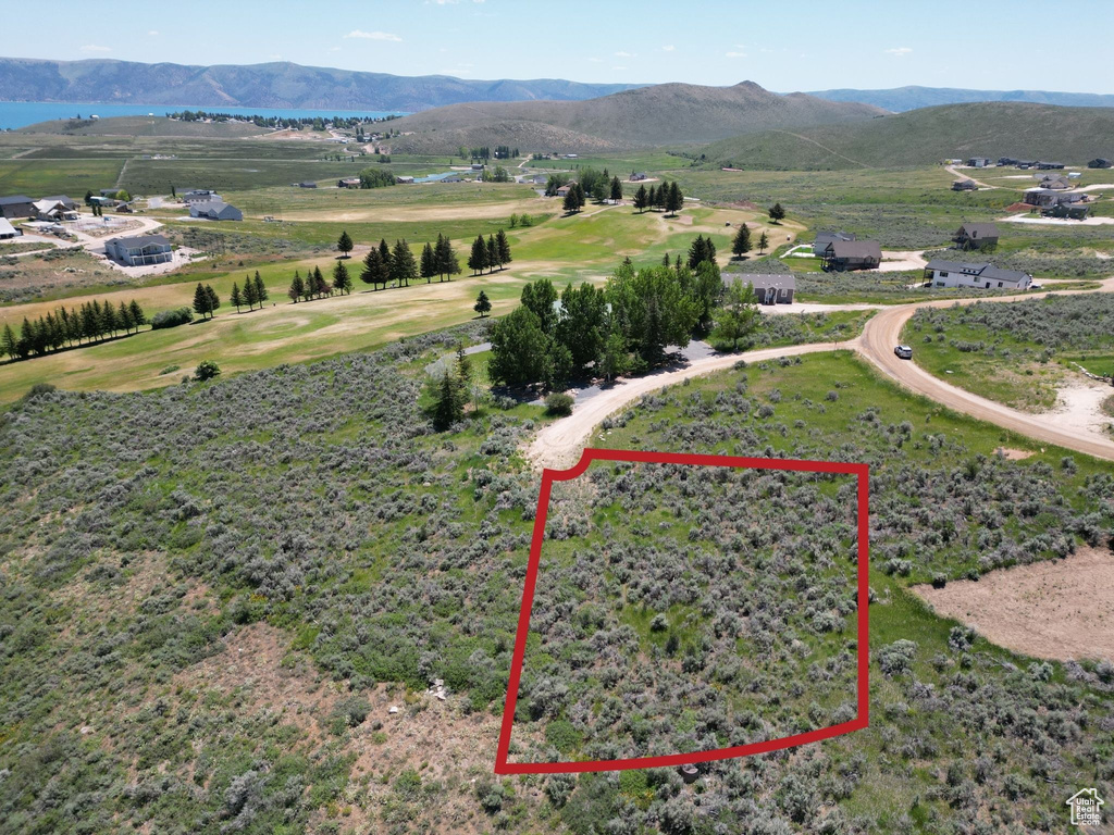 Aerial overview of property's location featuring property boundaries highlighted and a mountainous background