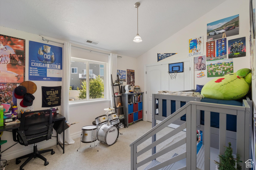Bedroom featuring carpet flooring, a desk, and lofted ceiling