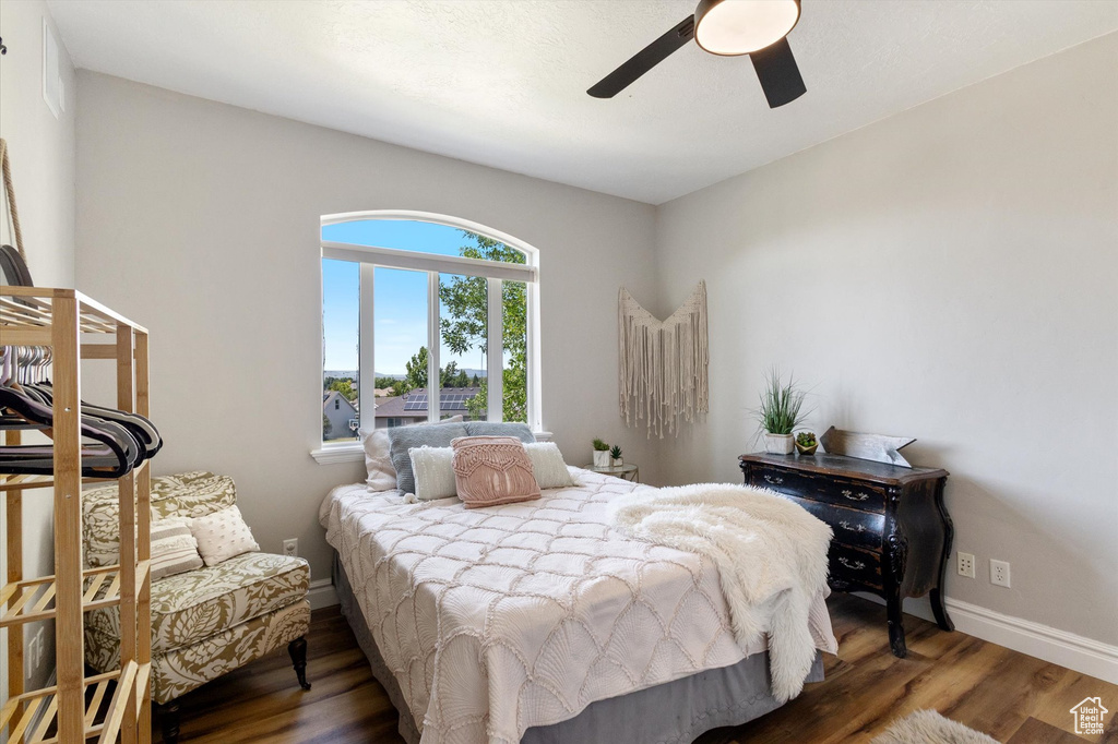Bedroom with wood finished floors and a ceiling fan