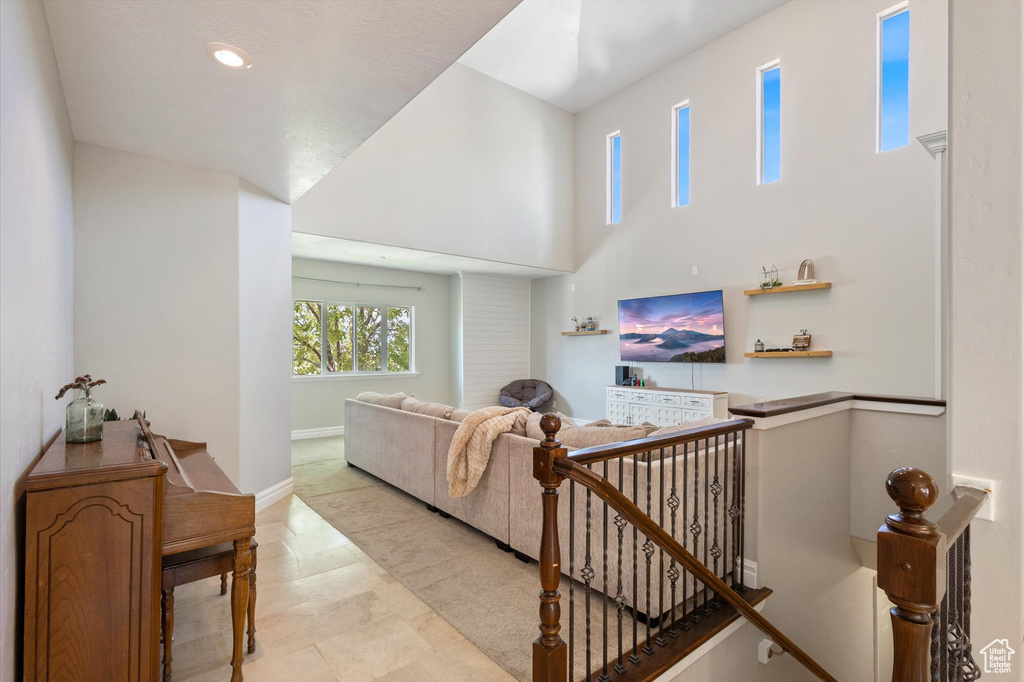 Living room featuring a towering ceiling and recessed lighting