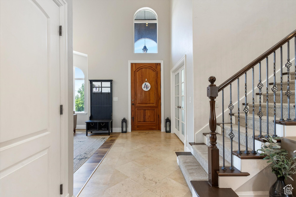 Entryway with a towering ceiling and stairs