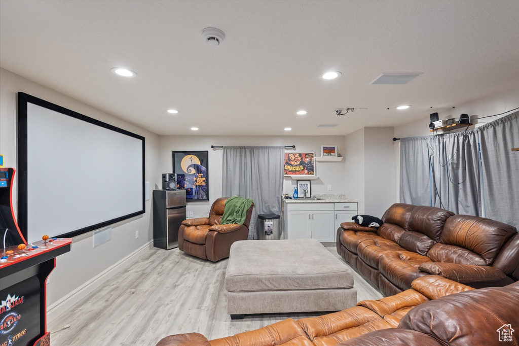 Cinema featuring recessed lighting and light wood-style floors