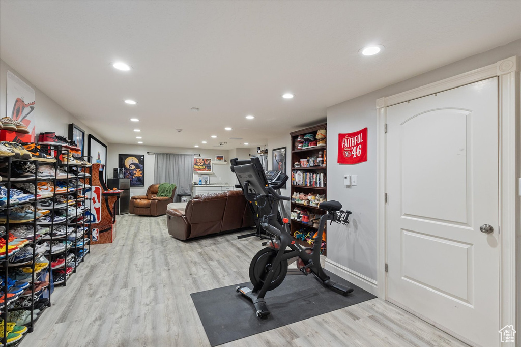 Workout area featuring light wood-type flooring and recessed lighting