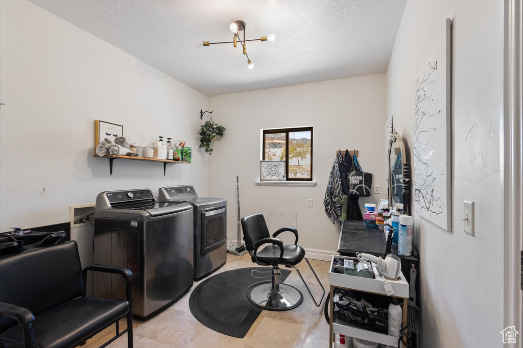 Office area featuring separate washer and dryer and a chandelier