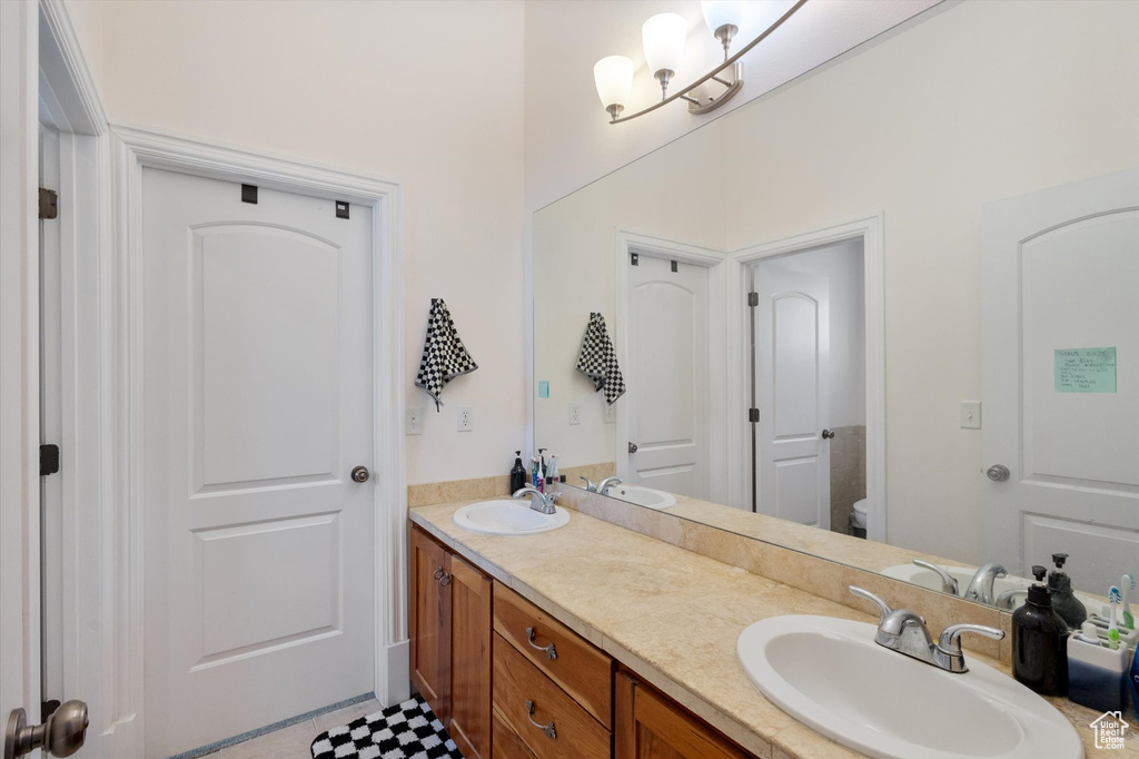 Full bath with double vanity and toilet