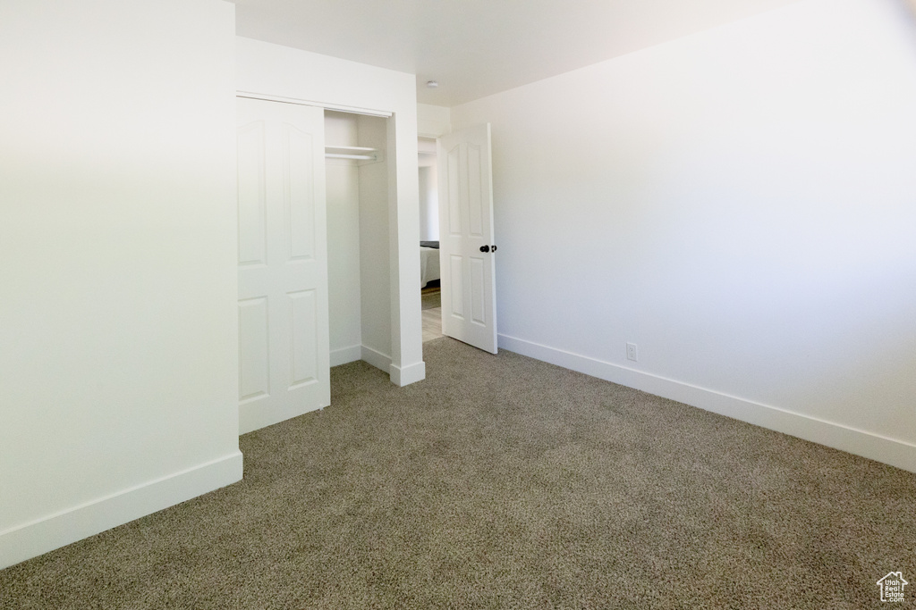 Unfurnished bedroom featuring carpet floors and a closet