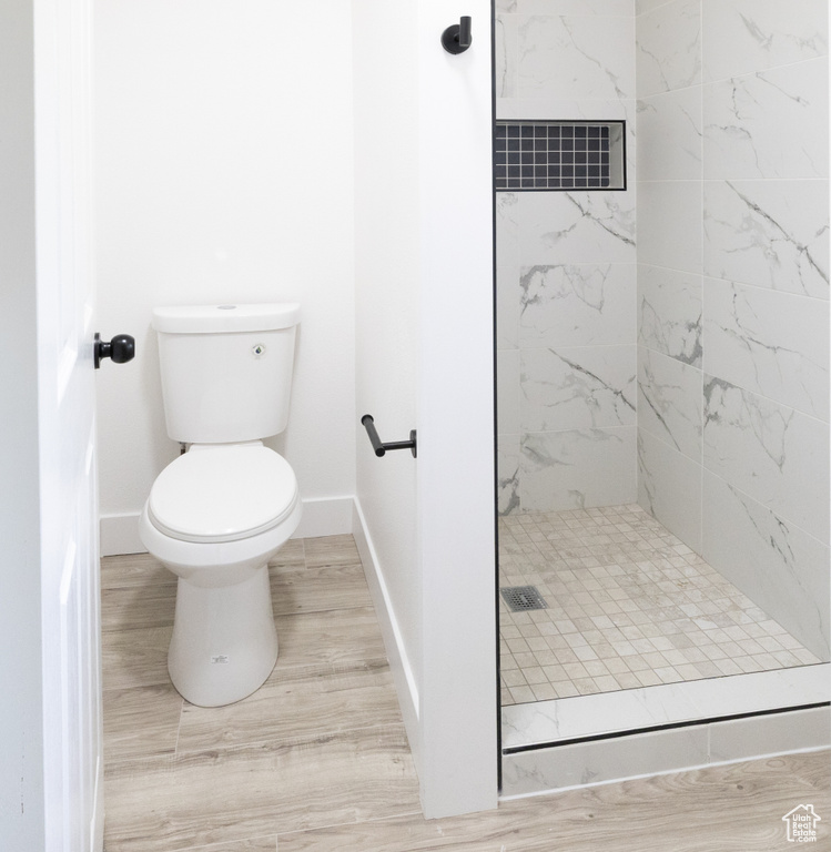 Bathroom featuring a shower stall and toilet