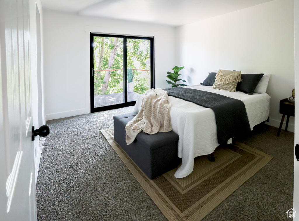 Carpeted bedroom featuring access to exterior and baseboards