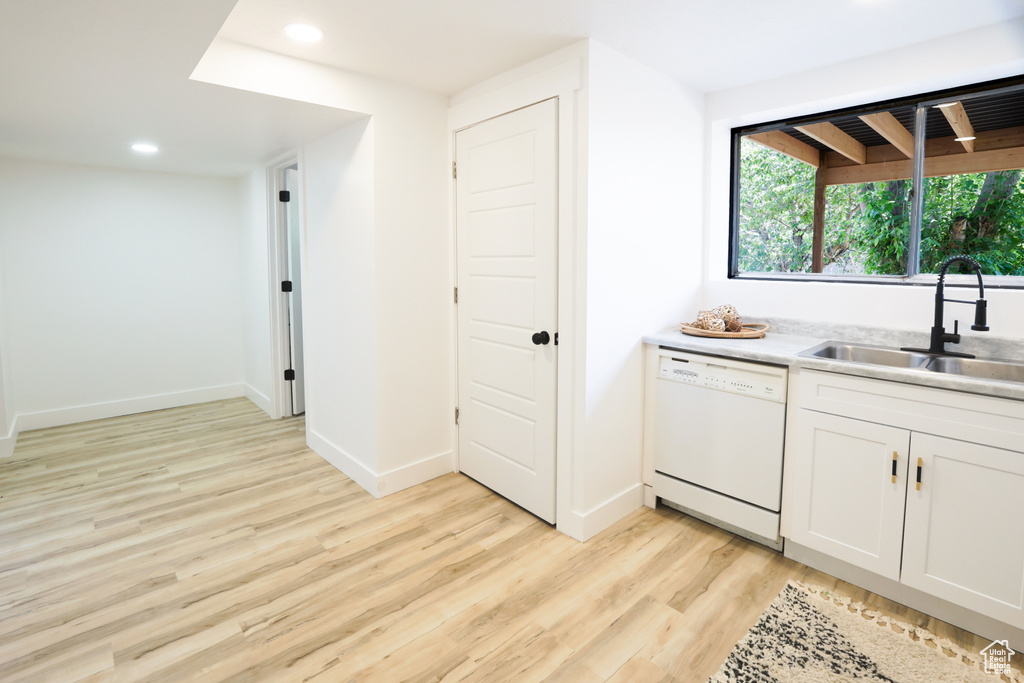 Bar area featuring white dishwasher, light wood-style flooring, and recessed lighting