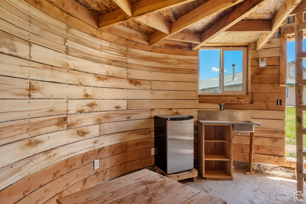 Miscellaneous room with wooden walls and a sink