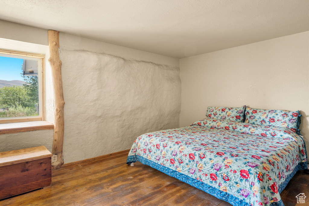 Bedroom with hardwood / wood-style flooring