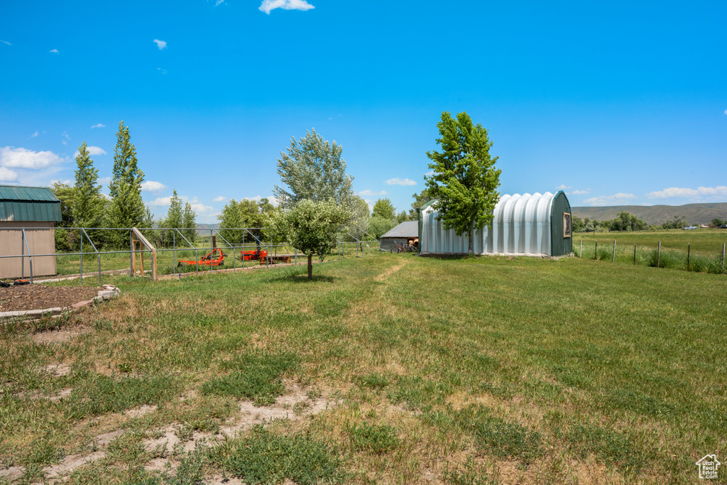 View of yard featuring an outbuilding and a pole building