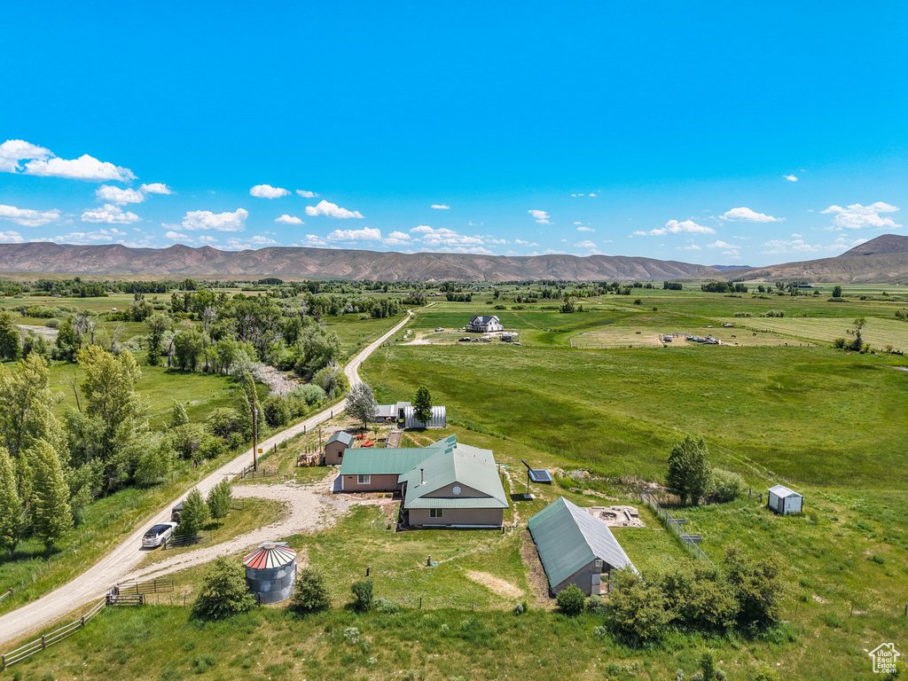 Aerial view of sparsely populated area featuring a mountain backdrop and agricultural land