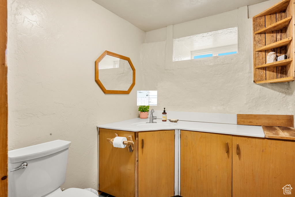 Bathroom featuring vanity and a textured wall