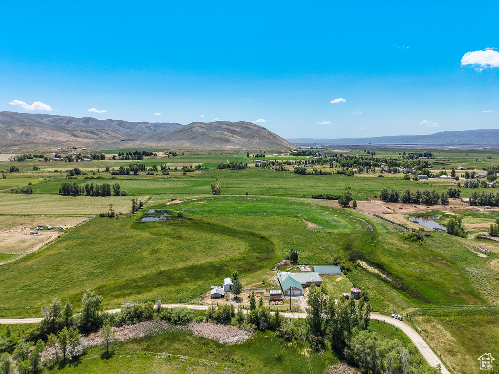 Aerial view of sparsely populated area featuring a mountainous background and agricultural land