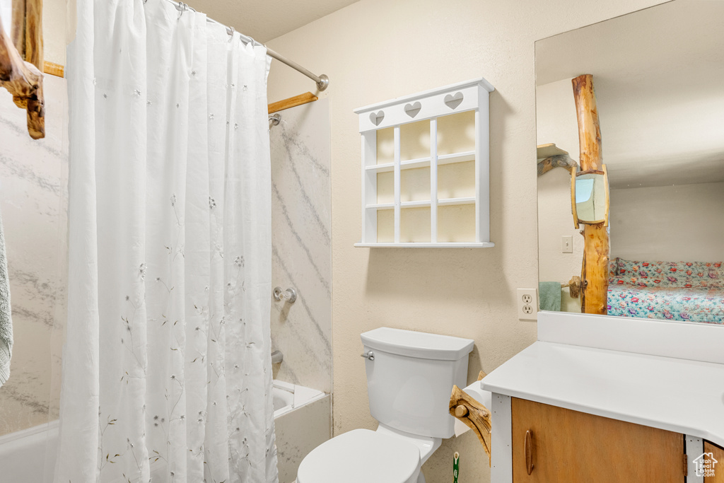 Full bath featuring shower / tub combo and vanity