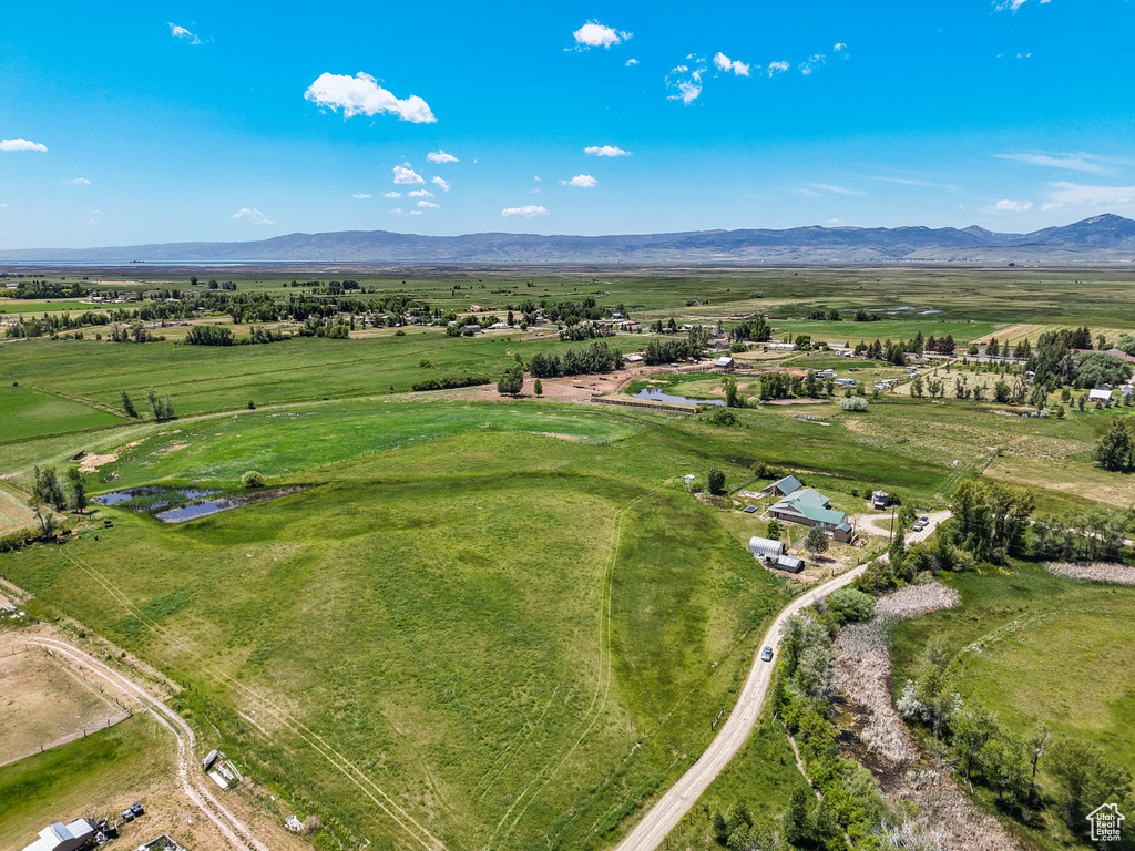 Aerial view of property's location with a mountain backdrop and rural landscape