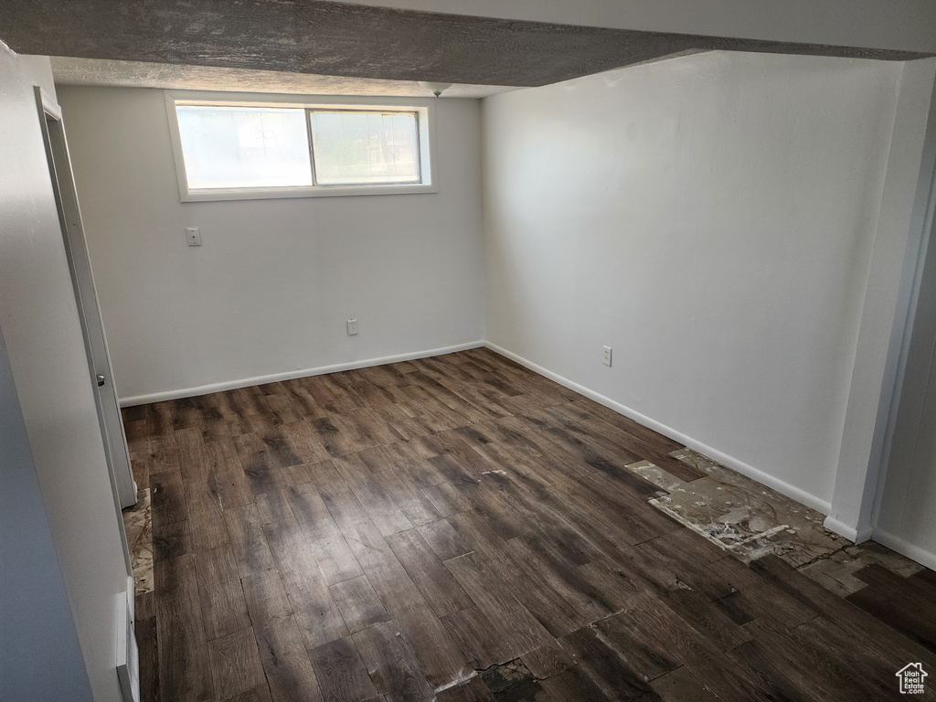 Below grade area featuring dark wood-style flooring