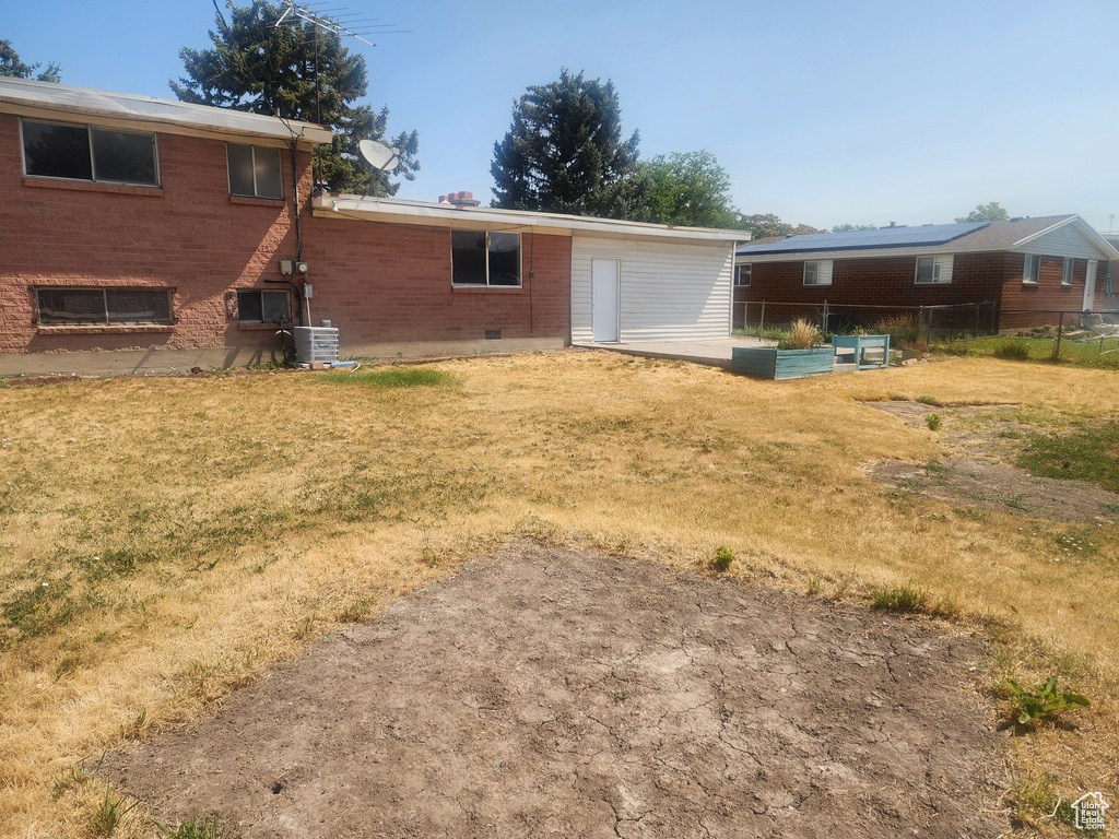 Rear view of property with brick siding