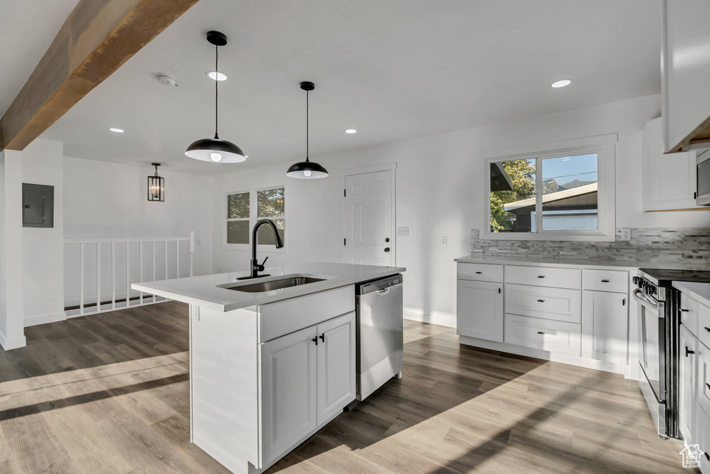 Kitchen featuring stainless steel appliances, dark wood-style floors, white cabinetry, and recessed lighting