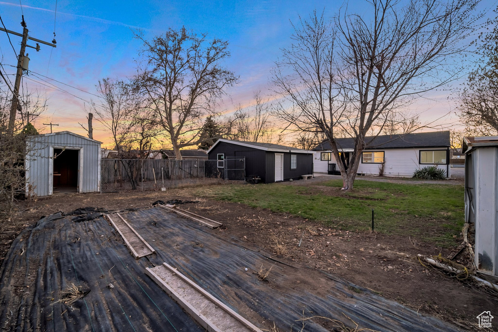 Deck at dusk featuring a storage shed