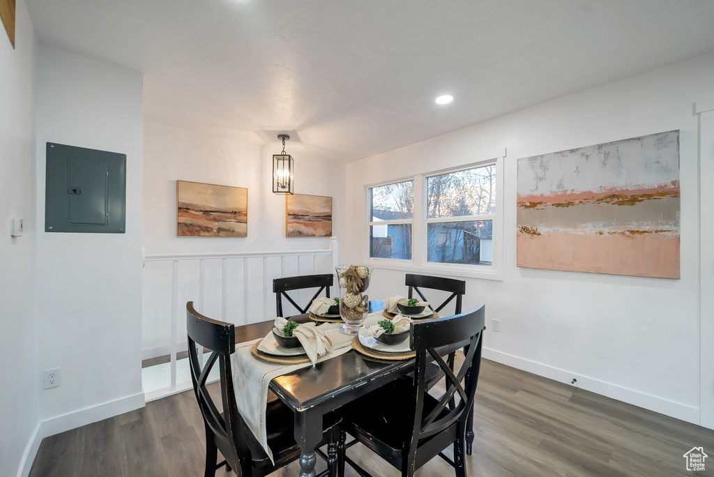 Dining space featuring electric panel, dark wood-type flooring, a chandelier, and recessed lighting