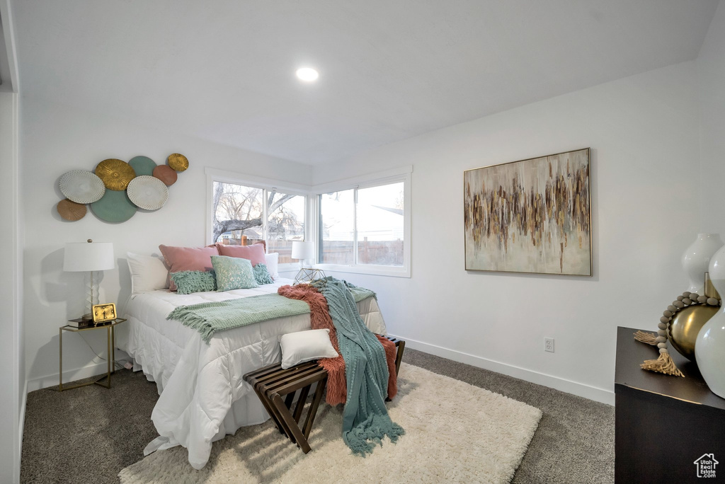 Carpeted bedroom featuring baseboards