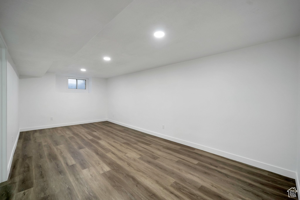 Below grade area featuring recessed lighting and dark wood-style flooring