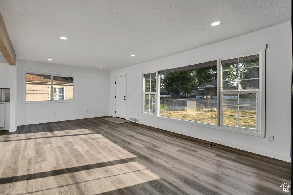 Unfurnished living room with recessed lighting and wood finished floors