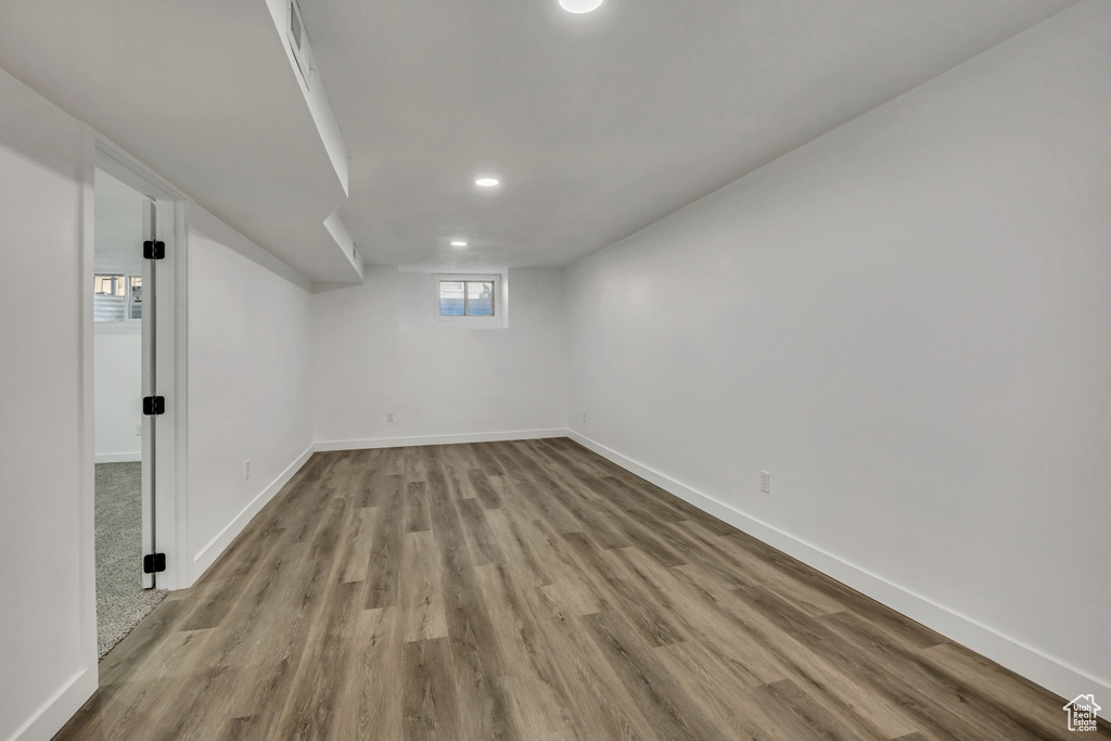 Below grade area with wood finished floors and recessed lighting
