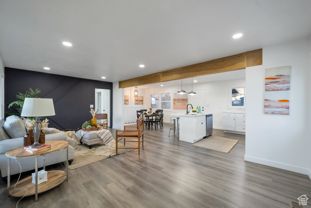 Living area featuring recessed lighting, wood finished floors, and beamed ceiling