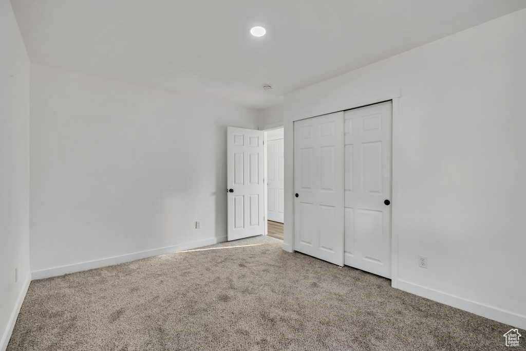 Unfurnished bedroom featuring carpet floors, a closet, and recessed lighting