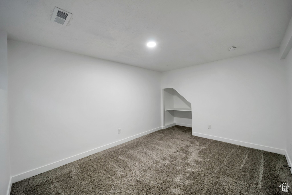 Empty room featuring carpet floors and baseboards