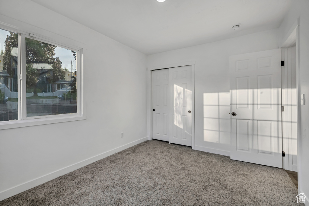 Unfurnished bedroom with carpet floors and a closet